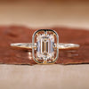 Emerald Cut Engagement Ring is designed with yellow gold ring.
