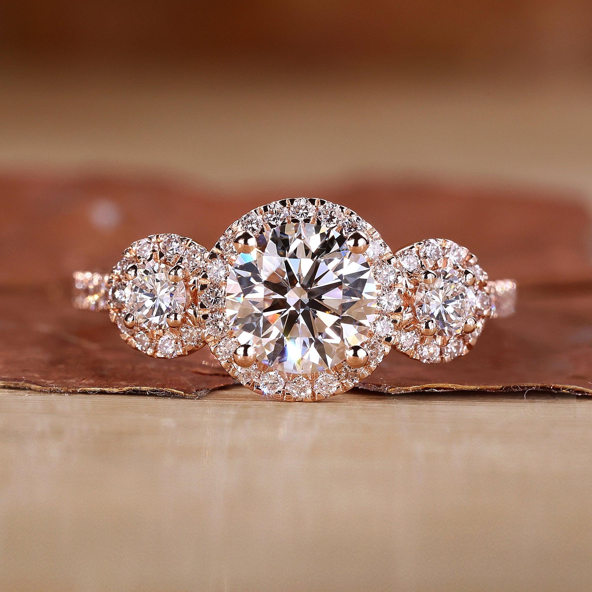 Three stone engagement ring in rose gold.
