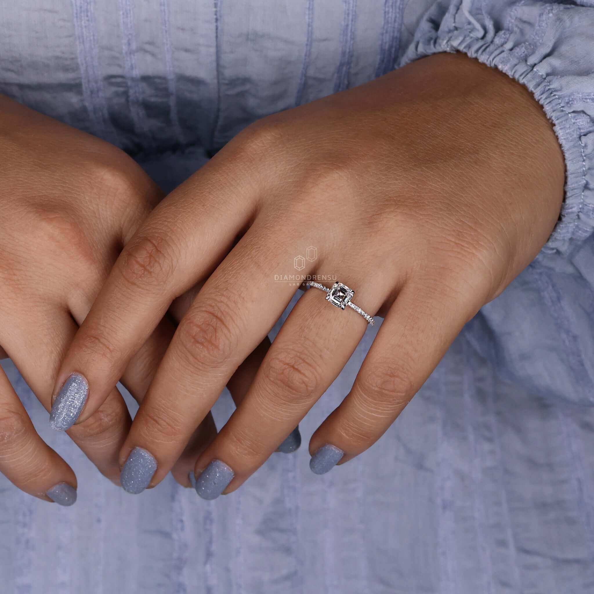 Stunning asscher cut engagement ring with a pave diamond band.