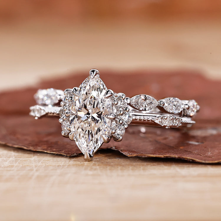 Marquise cut bridal set with round side stones and milgrain detailing.
