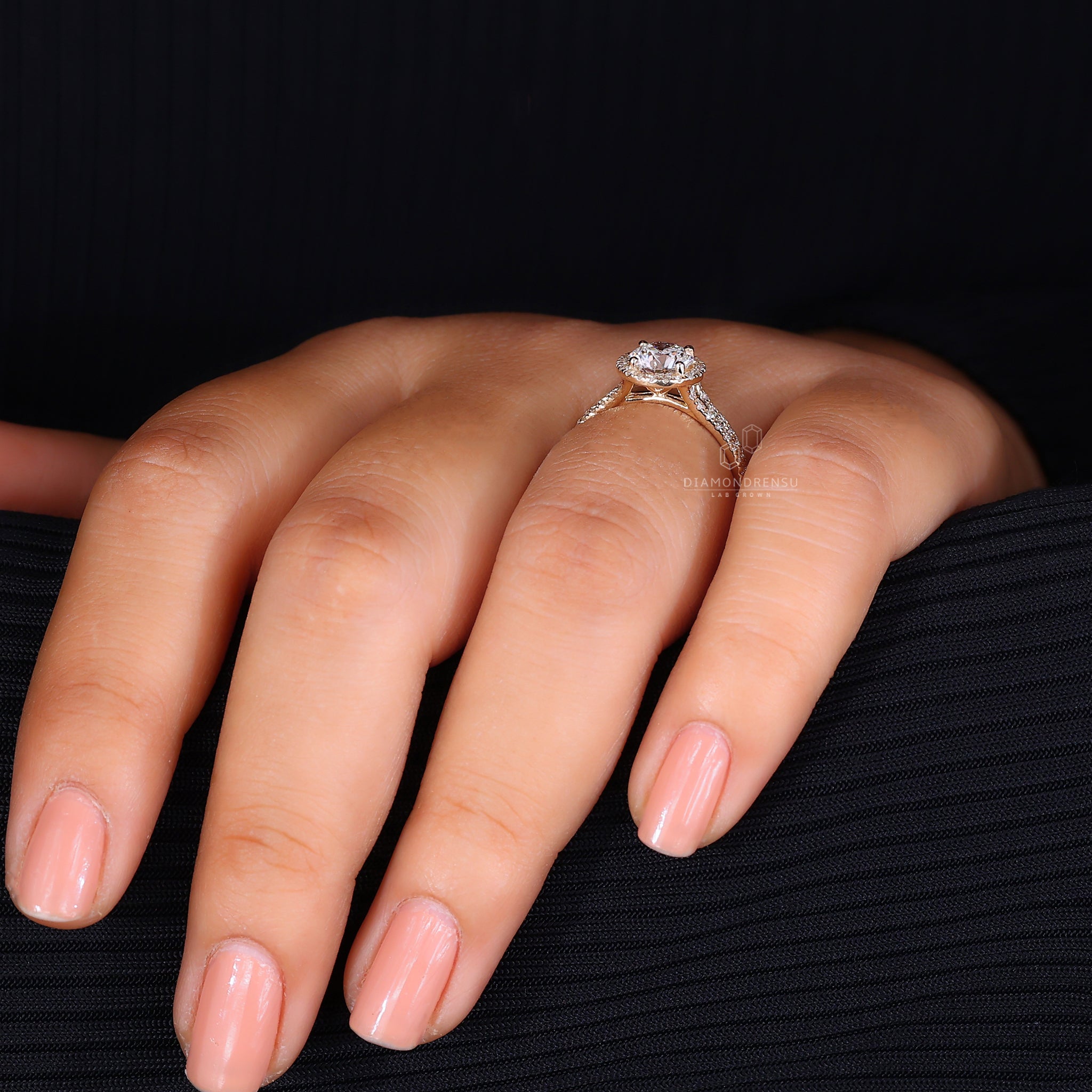 Round cut halo setting in yellow gold ring.
