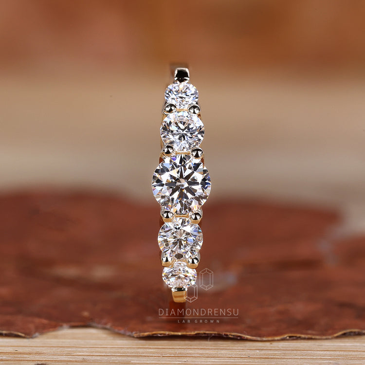 Elegant yellow gold wedding band with round cut diamonds
