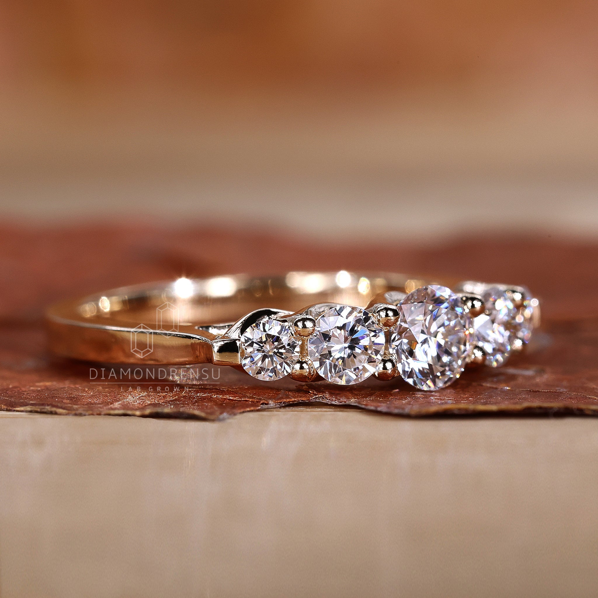 Trellis setting wedding ring with five round stones
