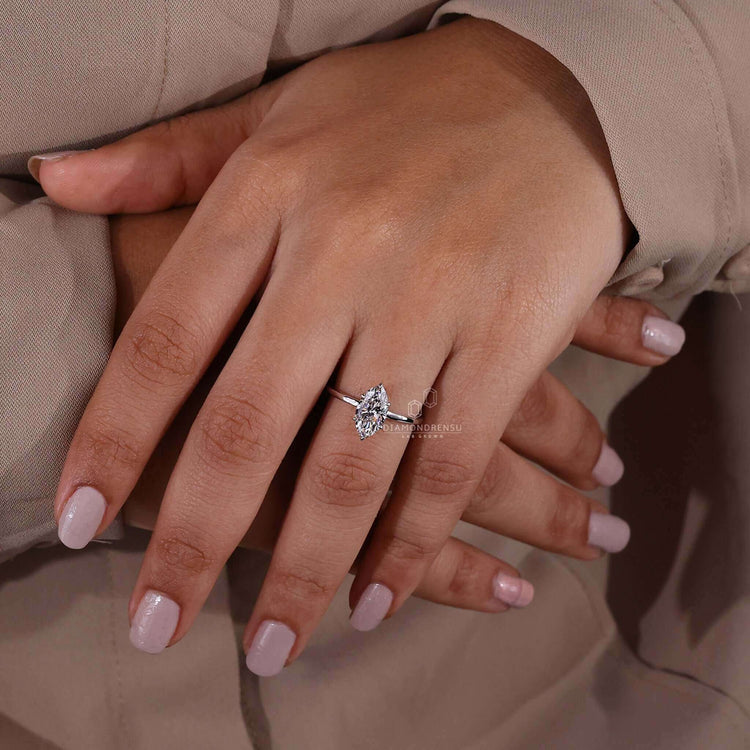 Hidden halo marquise engagement ring with intricate detailing.