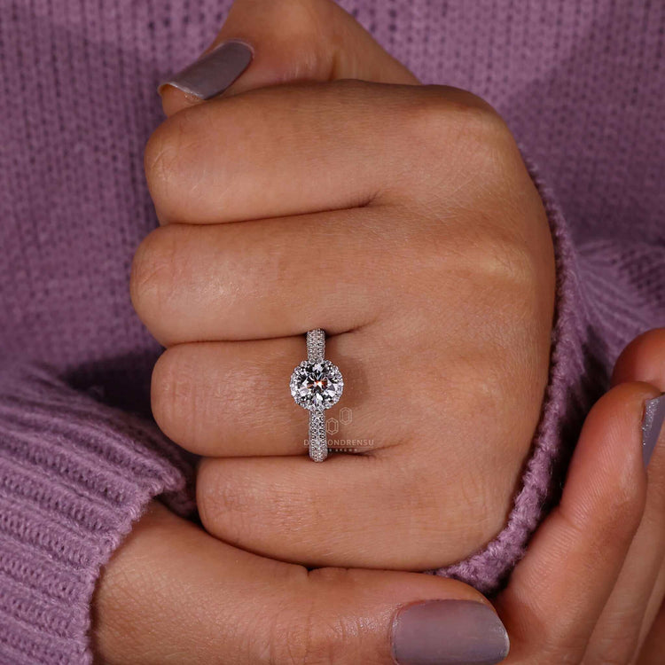 Diamond halo ring in a gold setting for an elegant engagement piece.