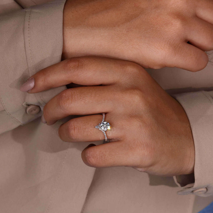 Engagement ring with pave details featuring a pear shaped ring and handcrafted design.