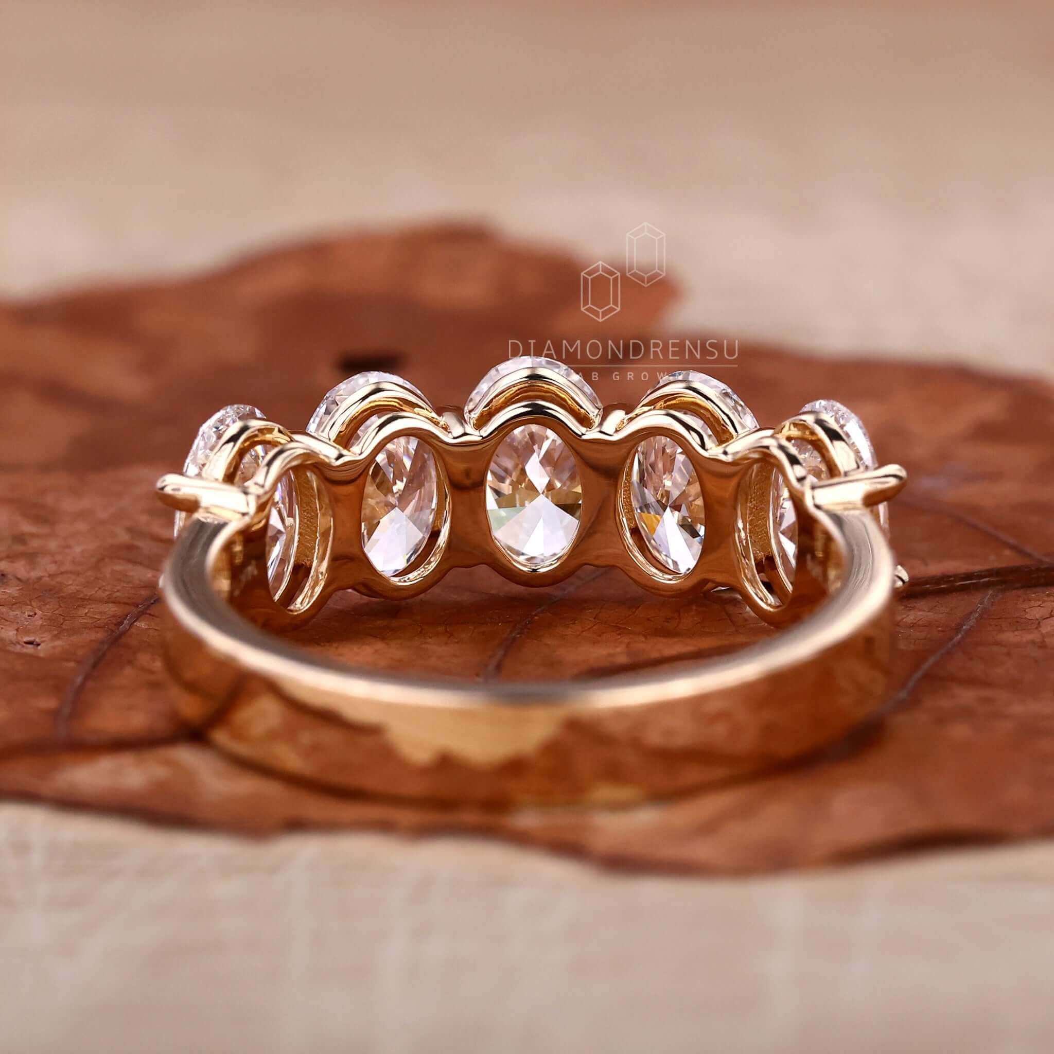 Gold oval shaped engagement ring with handmade design.