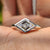 Lozenge cut moissanite engagement ring in white gold.
