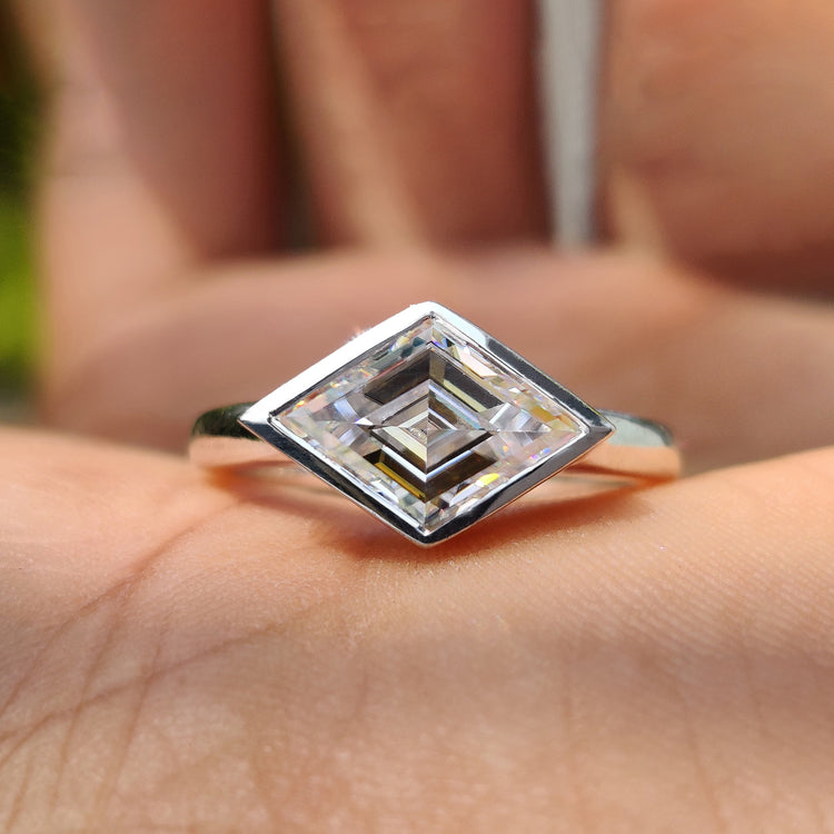 Lozenge cut moissanite engagement ring in white gold.
