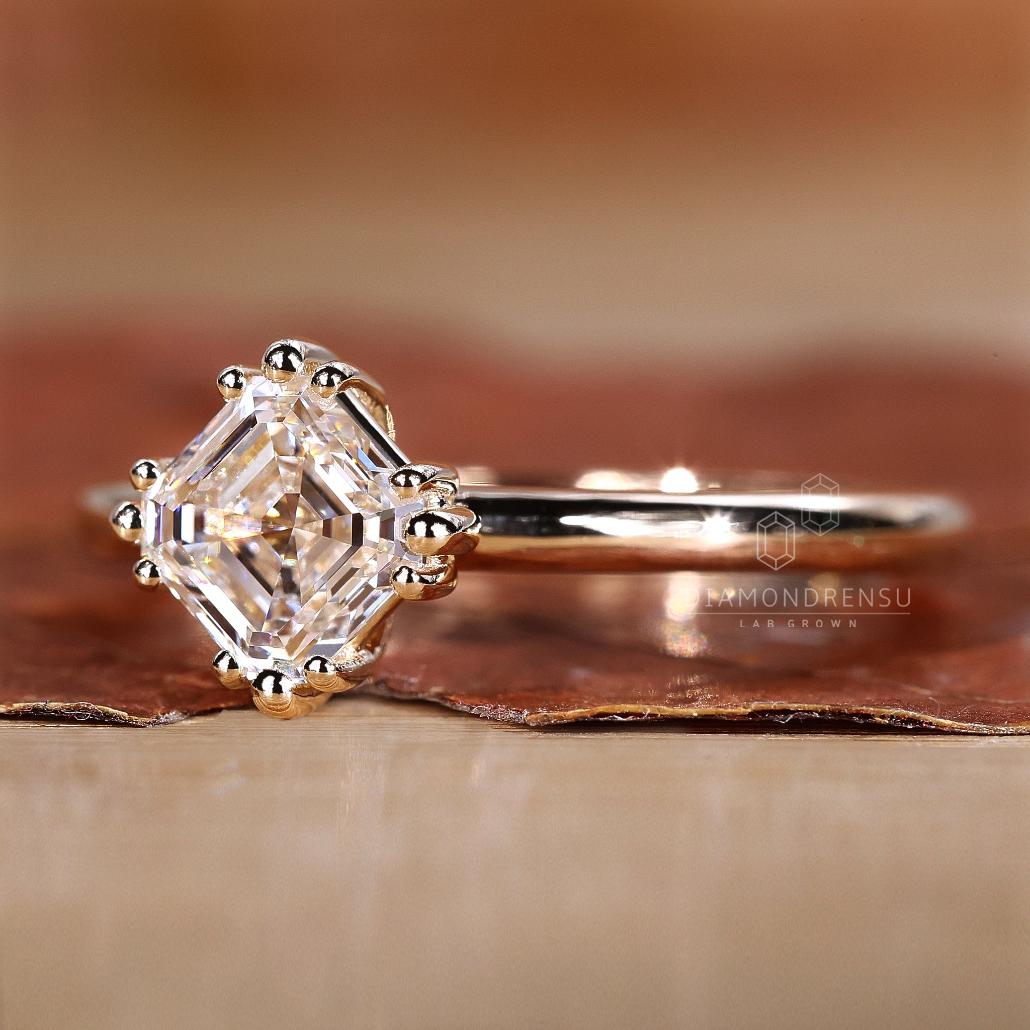 Solitaire ring featuring Asscher cut diamond.
