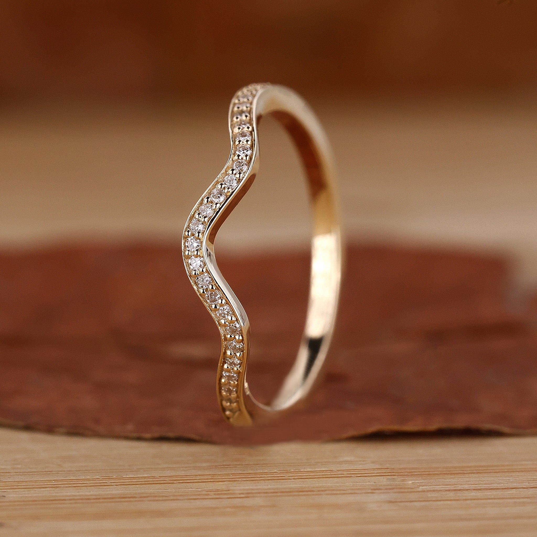 Curved diamond wedding band in yellow gold
