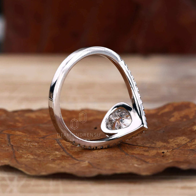 Pear engagement ring in a chevron style ring design, highlighting the beauty of a pear shaped diamond.
