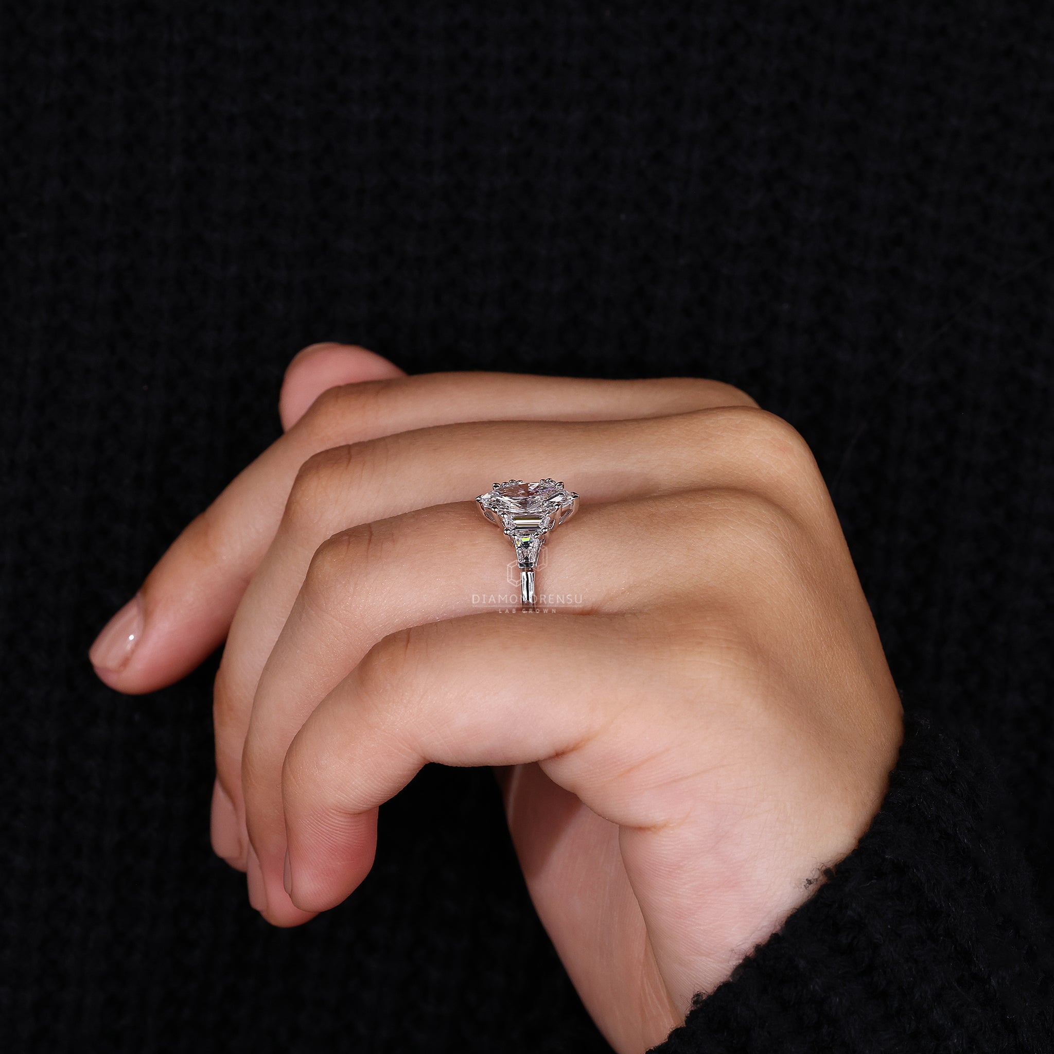 V prong holds the center stone while prong setting secures all diamonds.
