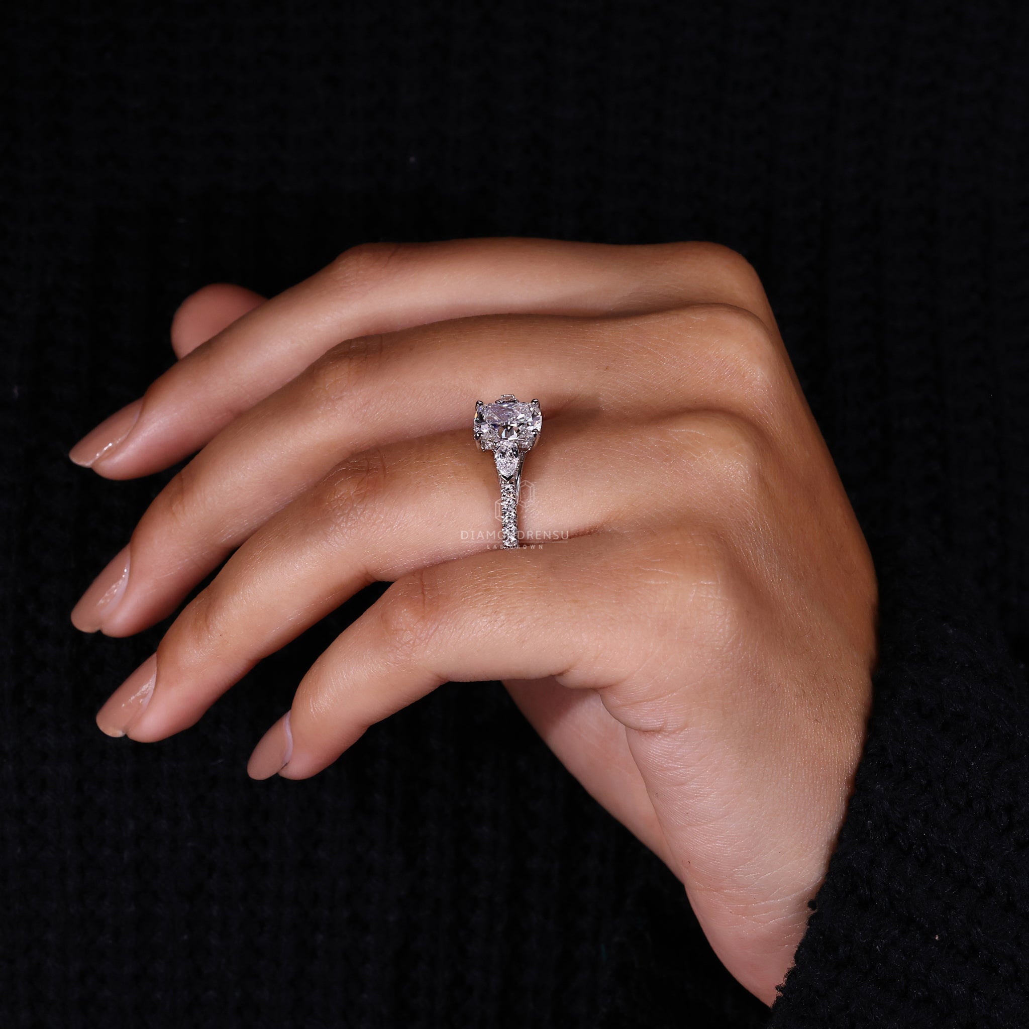 Pear diamond ring with round engagement ring design
