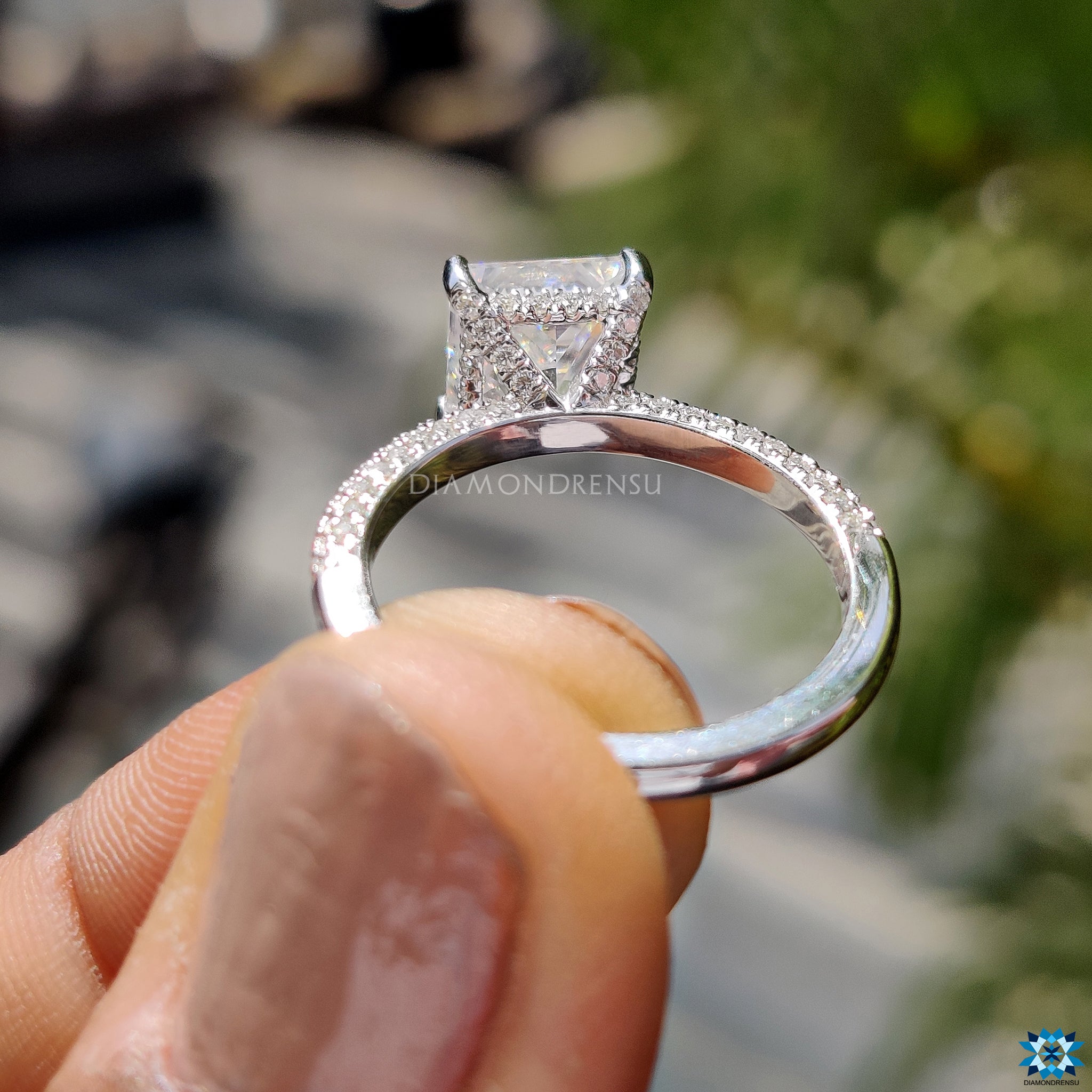 White gold ring featuring hidden halo and 3 sided pave setting.

