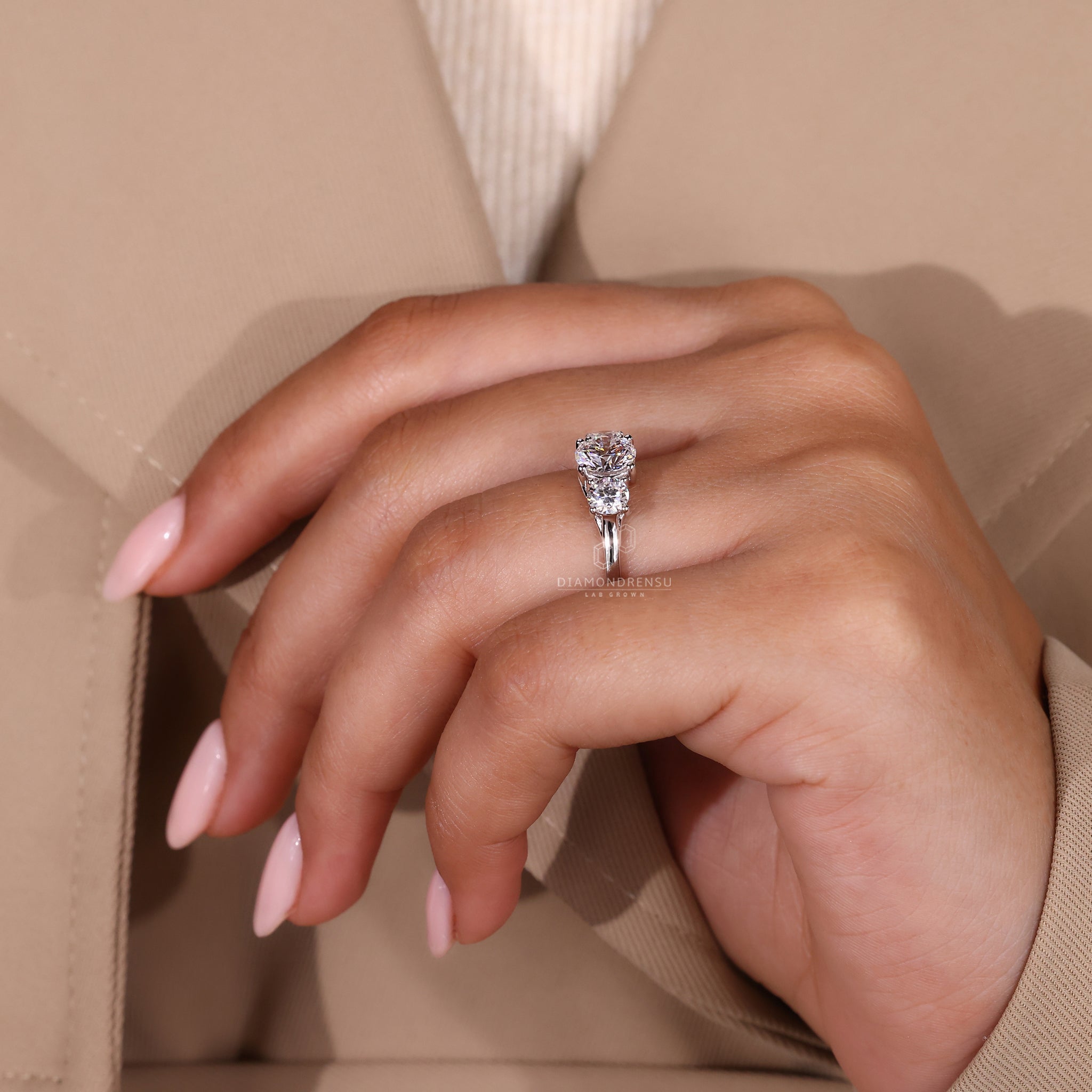 Diamondrensu UK engagement ring with white gold band and trellis setting.
