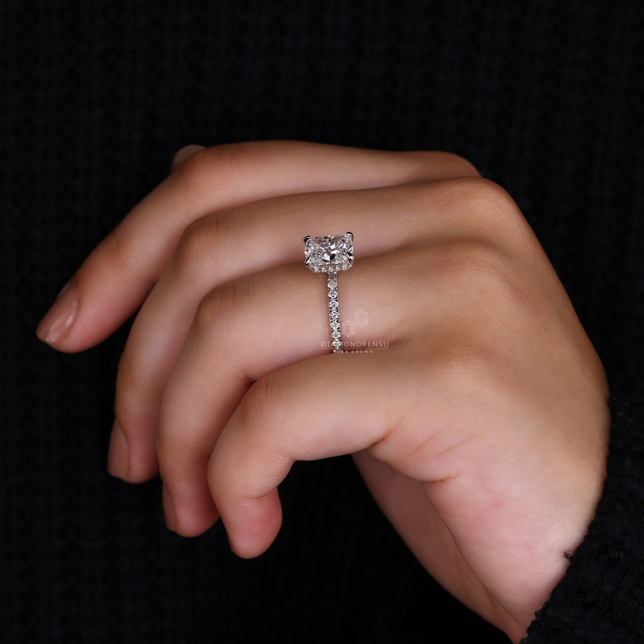 Proposal engagement ring with round diamond pave band and white gold finish.
