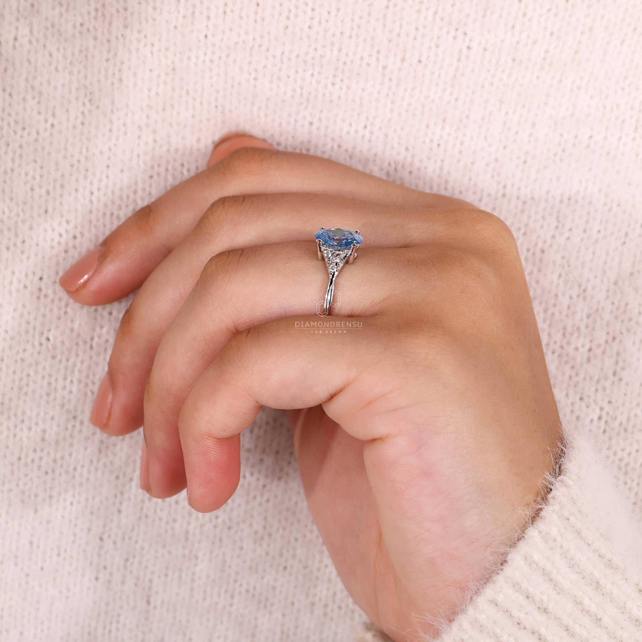 UK engagement ring with oval centre and marquise side stones.
