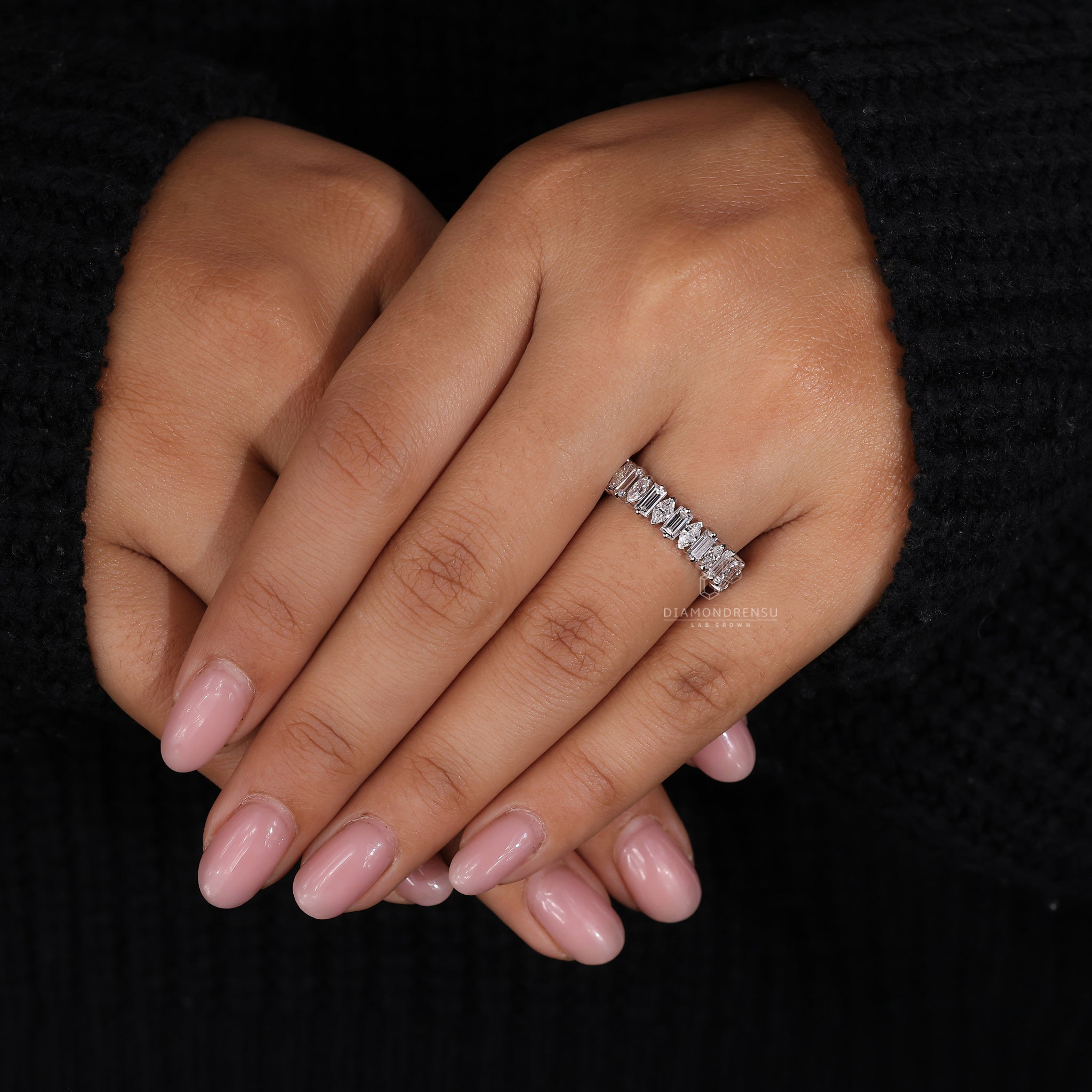 White gold wedding band with V and round prongs.
