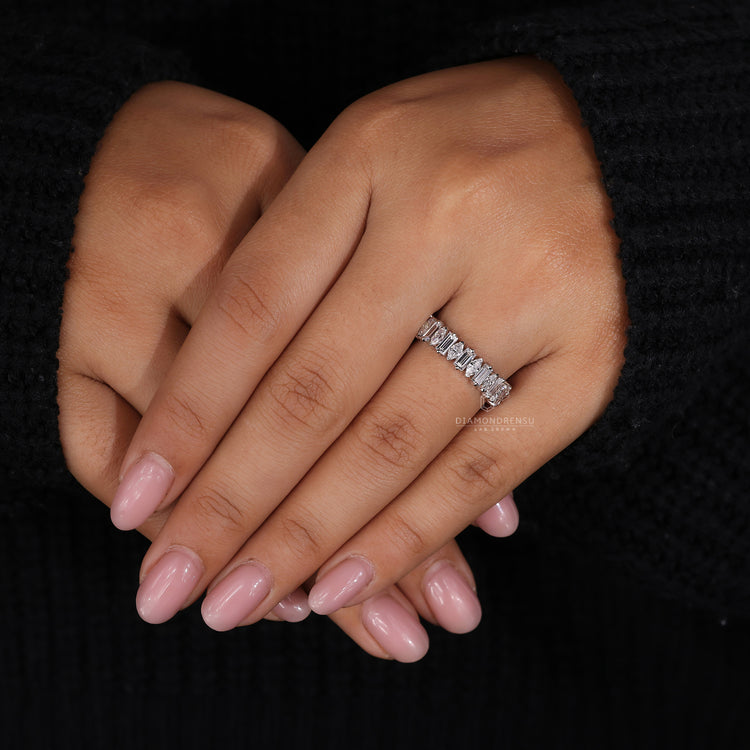 White gold wedding band with V and round prongs.
