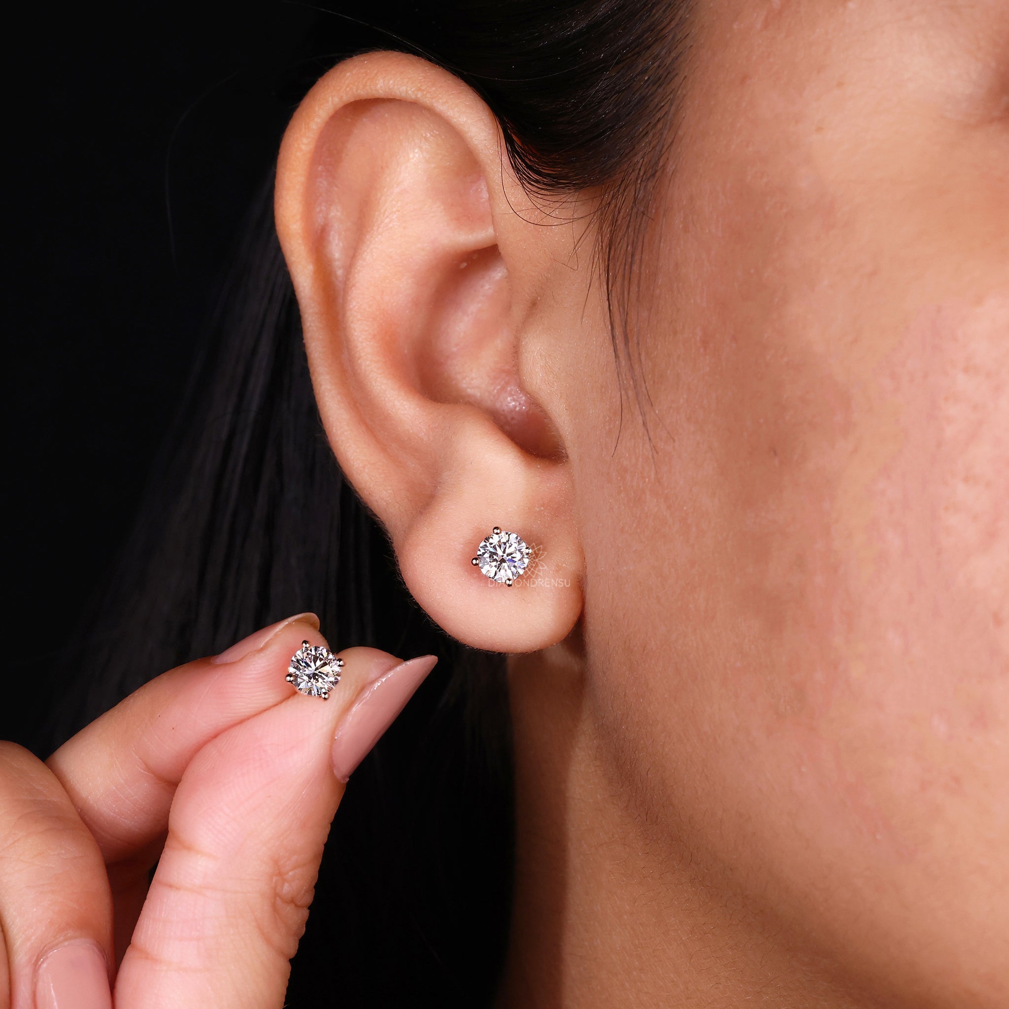 Custom diamond earrings designed as rose gold round studs.