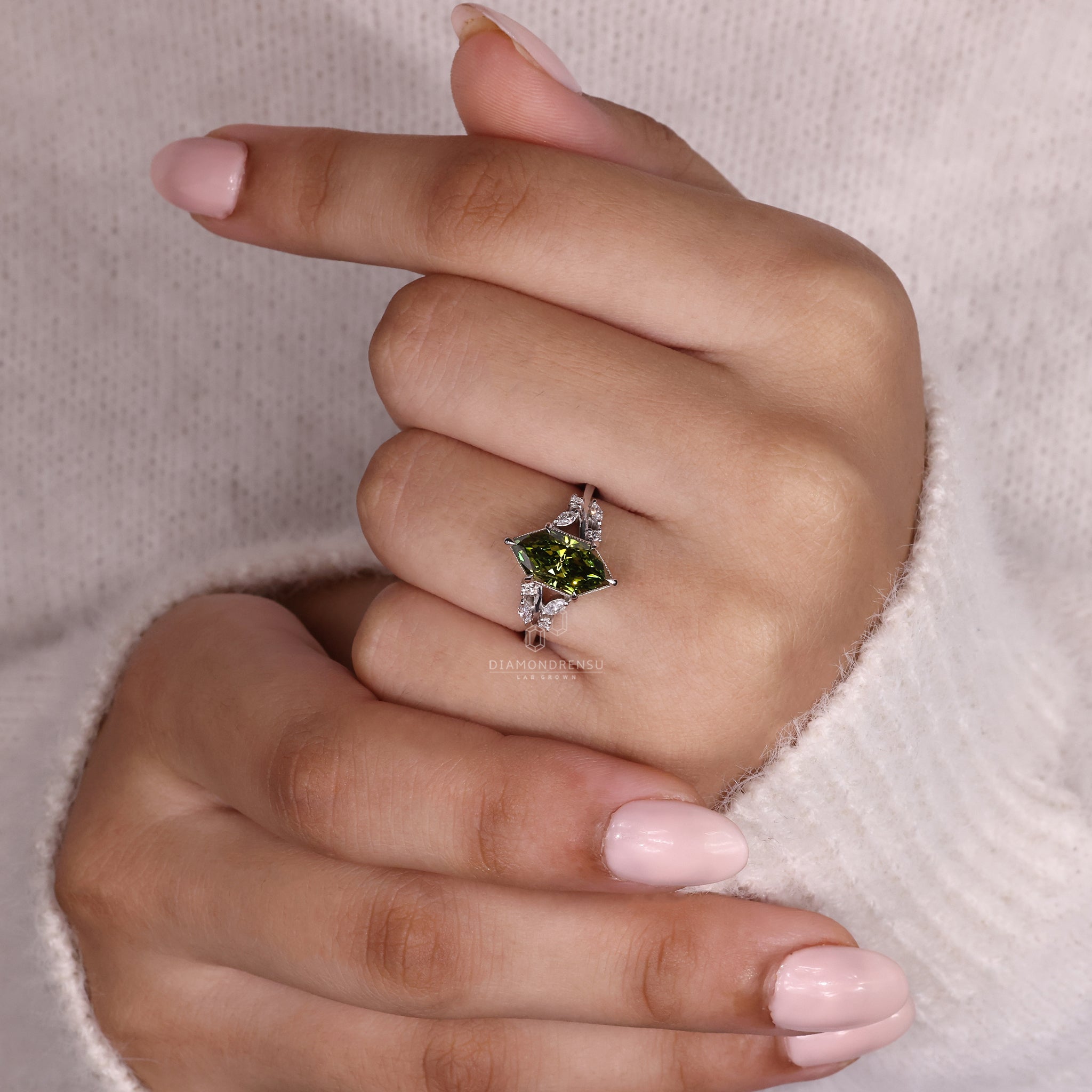 White gold ring with intricate nature-inspired design.