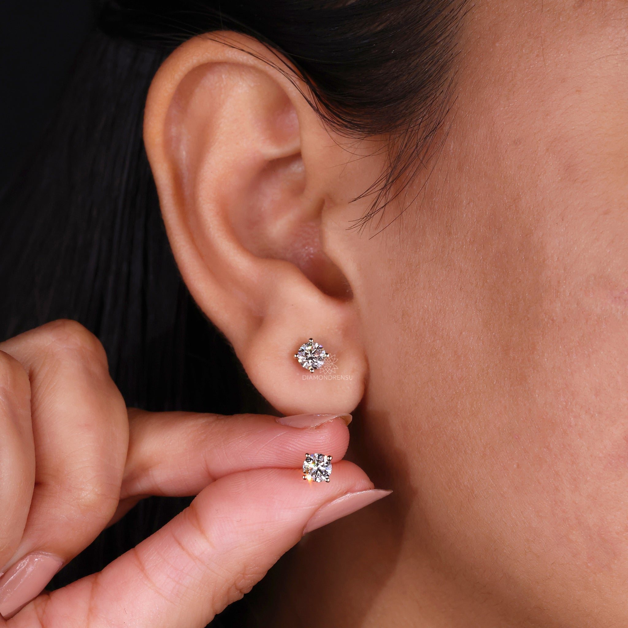 Custom diamond earrings crafted as simple round studs in yellow gold.