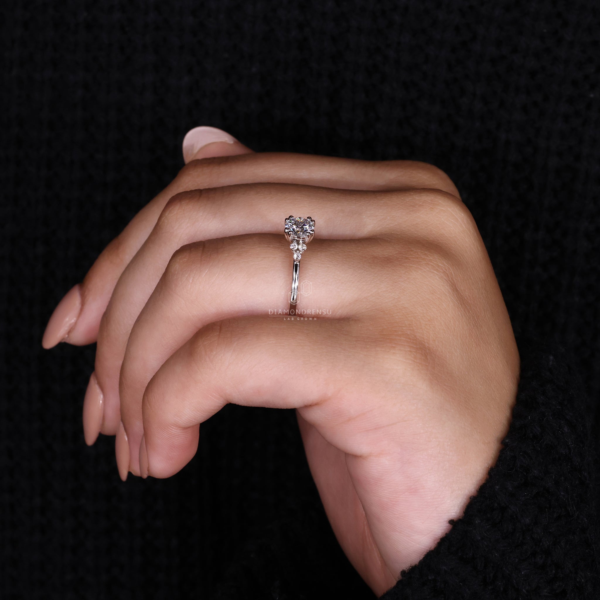 Round diamond engagement ring with double prong setting and minimalist style.
