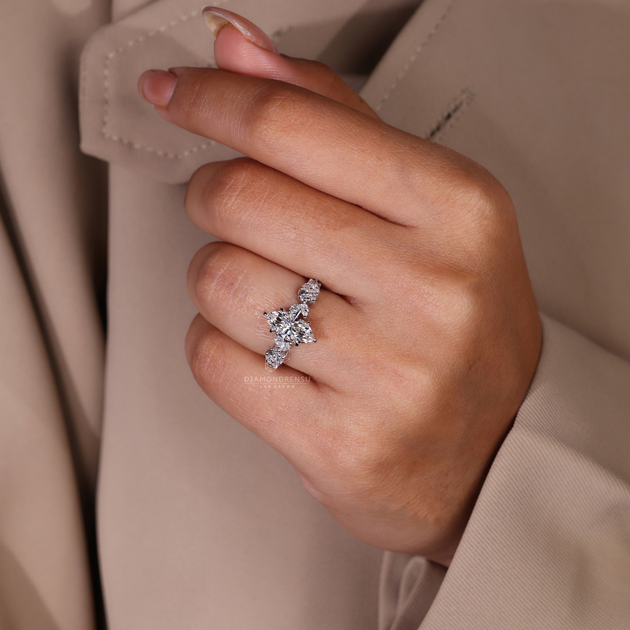 Marquise and round side diamond ring in six claw prong set.
