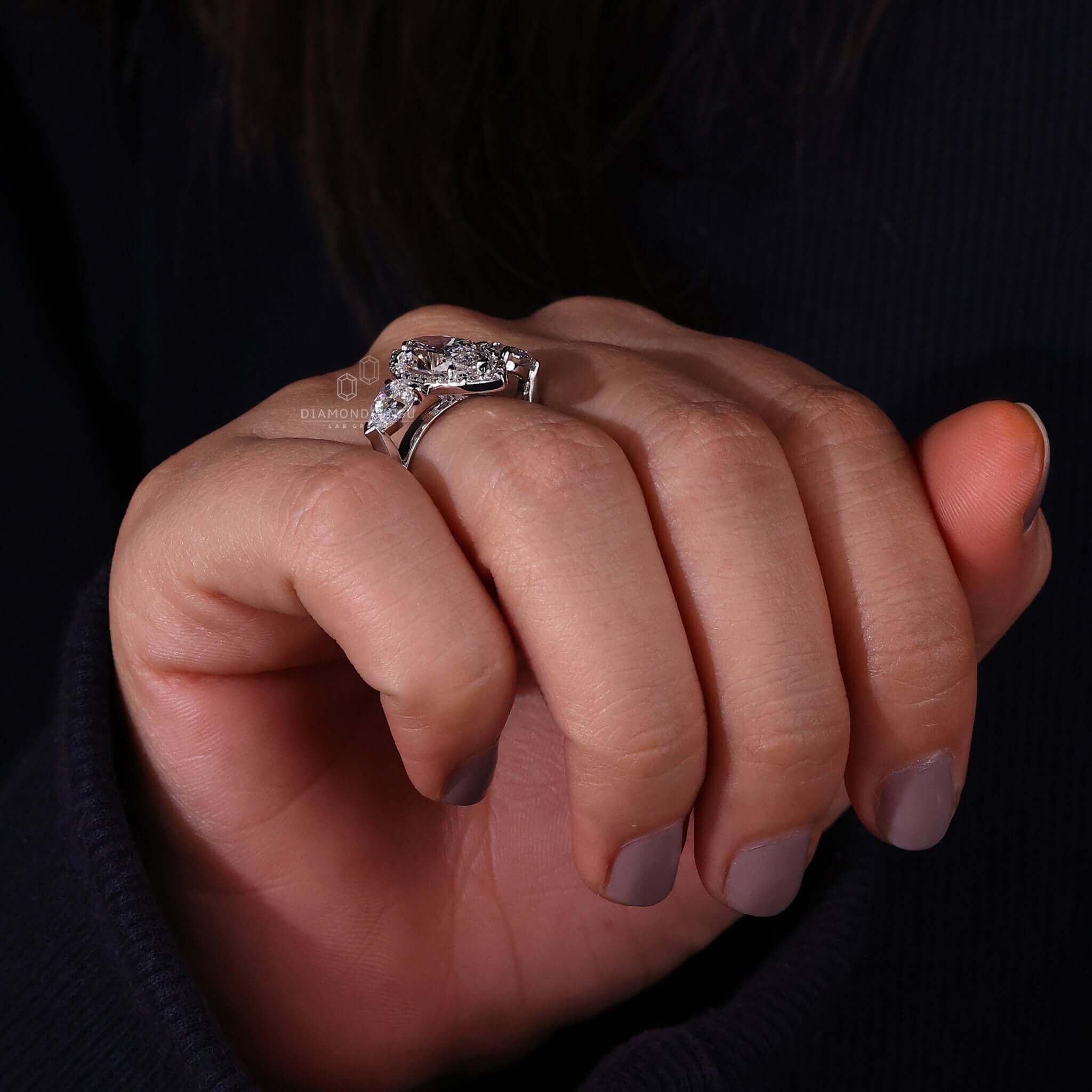 Three stone engagement ring with a marquise centre diamond and lab grown diamonds.