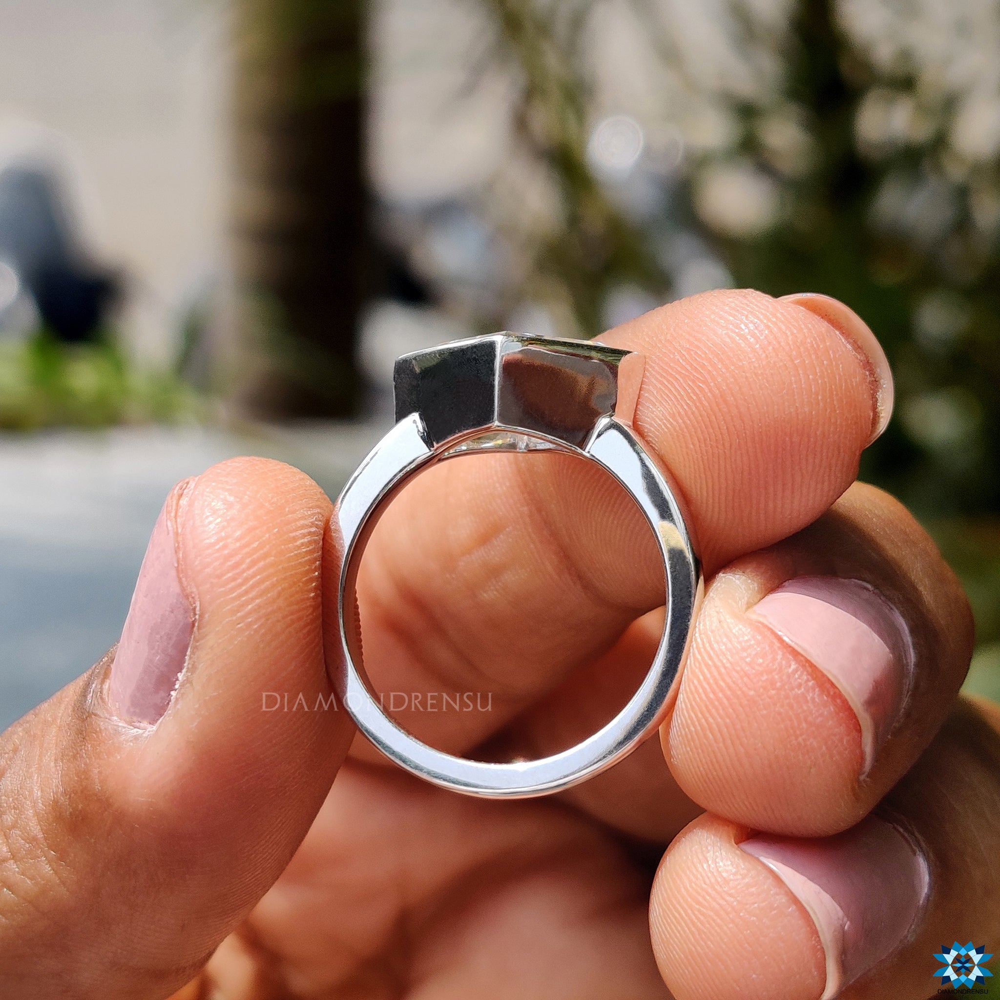 White gold ring with east to west lozenge cut moissanite.
