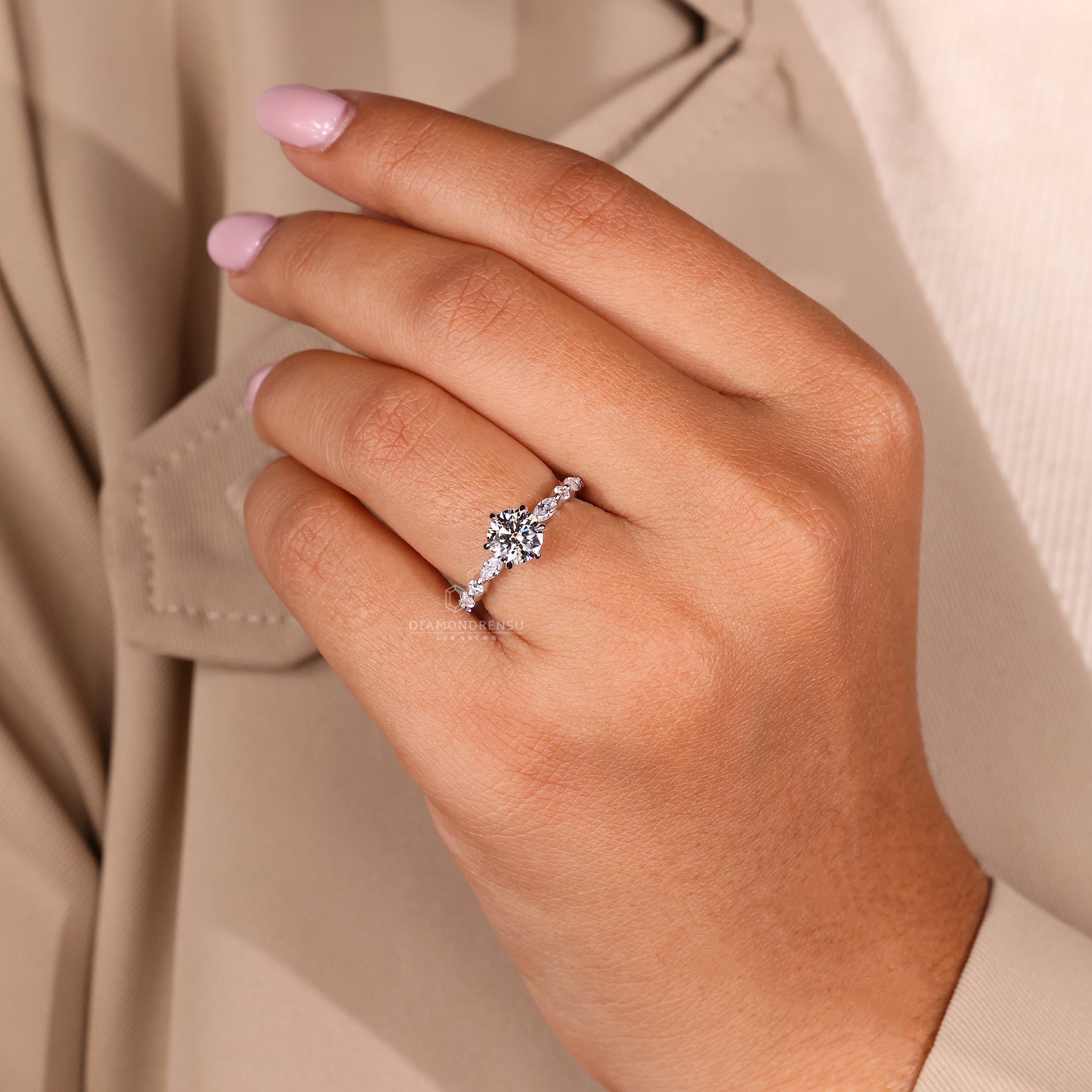 Custom diamond ring with round cut centre stone and shared prong setting.
