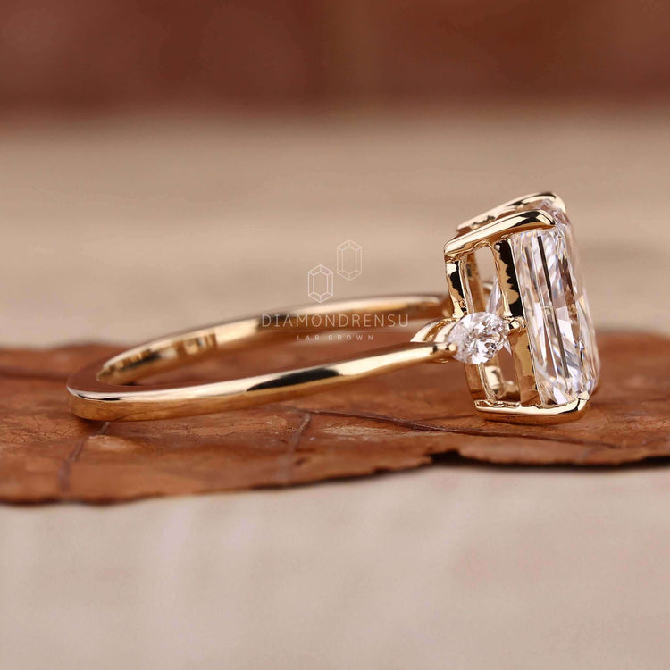Radiant cut ring with a marquise diamond ring accent, designed as a stunning handmade jewellery piece.\