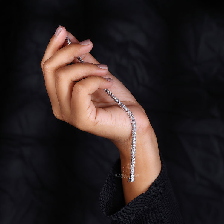 White gold bracelet with round diamonds arranged in a tennis design.
