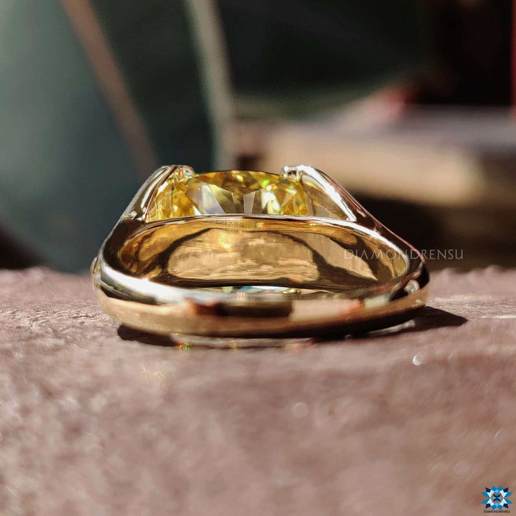 Tension setting ring with bold canary yellow cushion moissanite.
