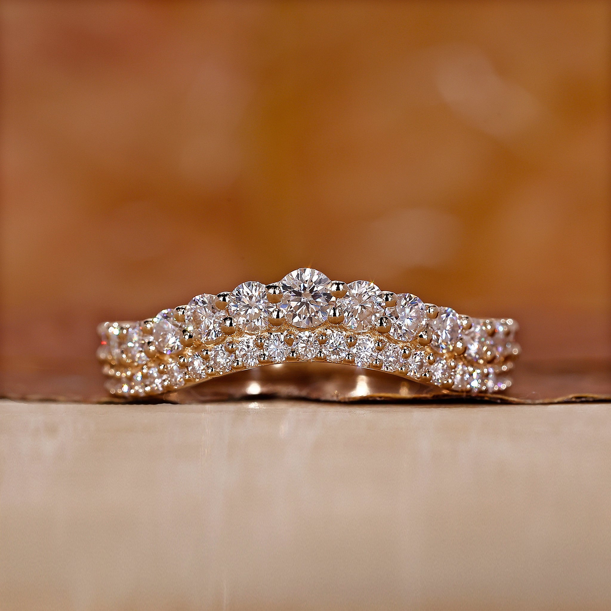 Curved diamond wedding band in yellow gold.
