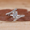 Emerald shape engagement ring with bypass design in white gold.
