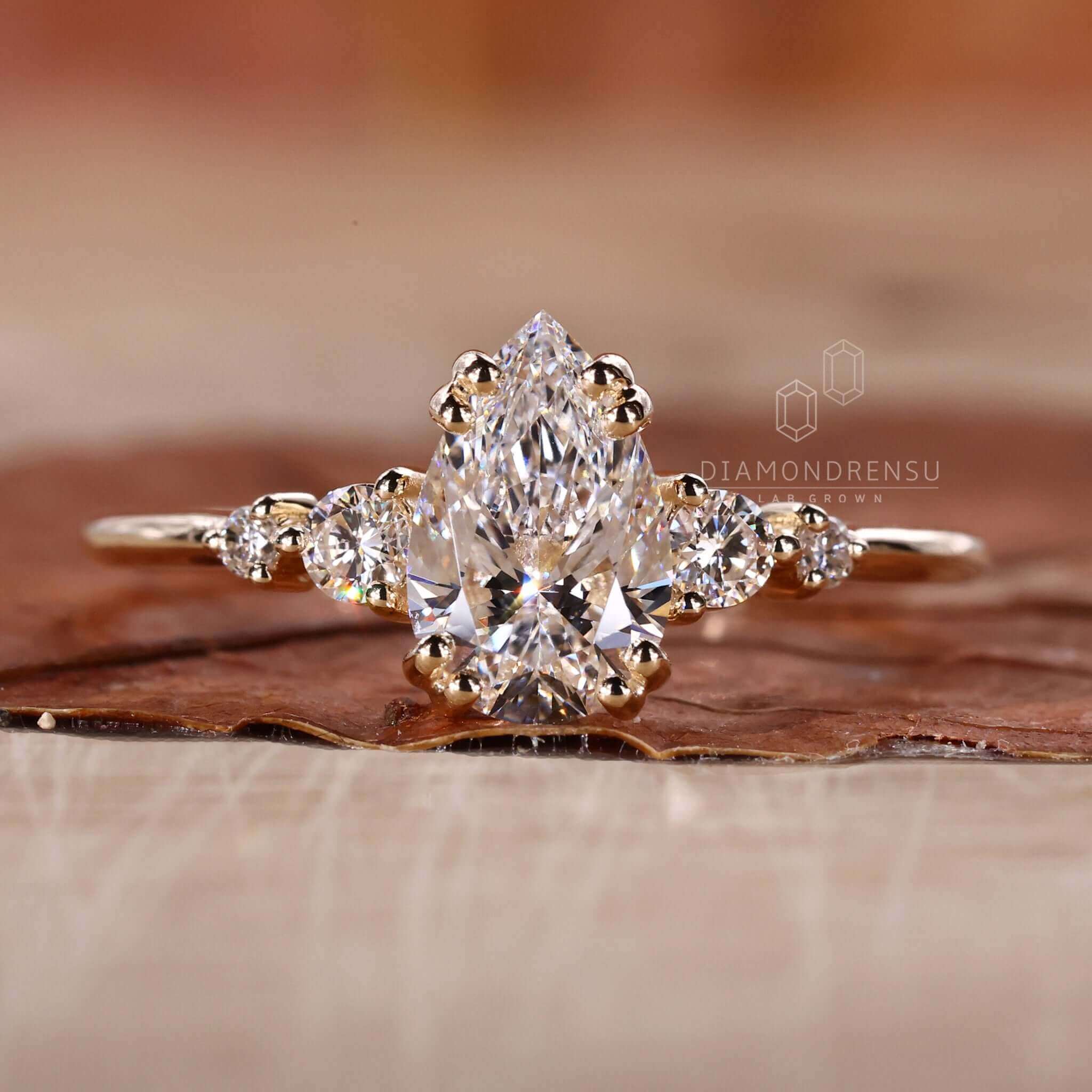 Pear shaped diamond ring featuring a 5 stone diamond ring design for elegant sparkle.
