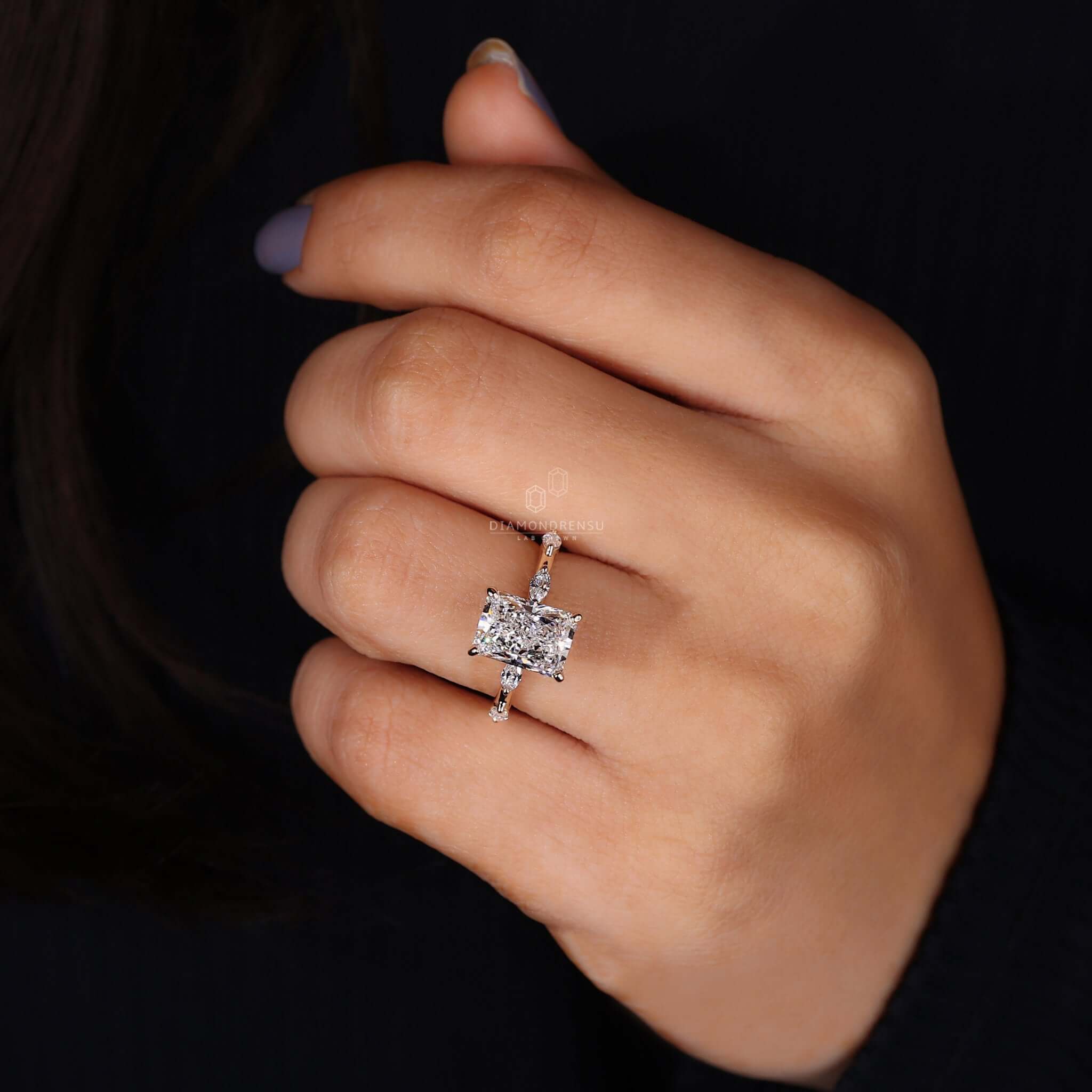 A marquise side stone engagement ring with vintage-inspired elegance and intricate detailing.