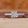 Princess cut diamond engagement ring with pave setting.
