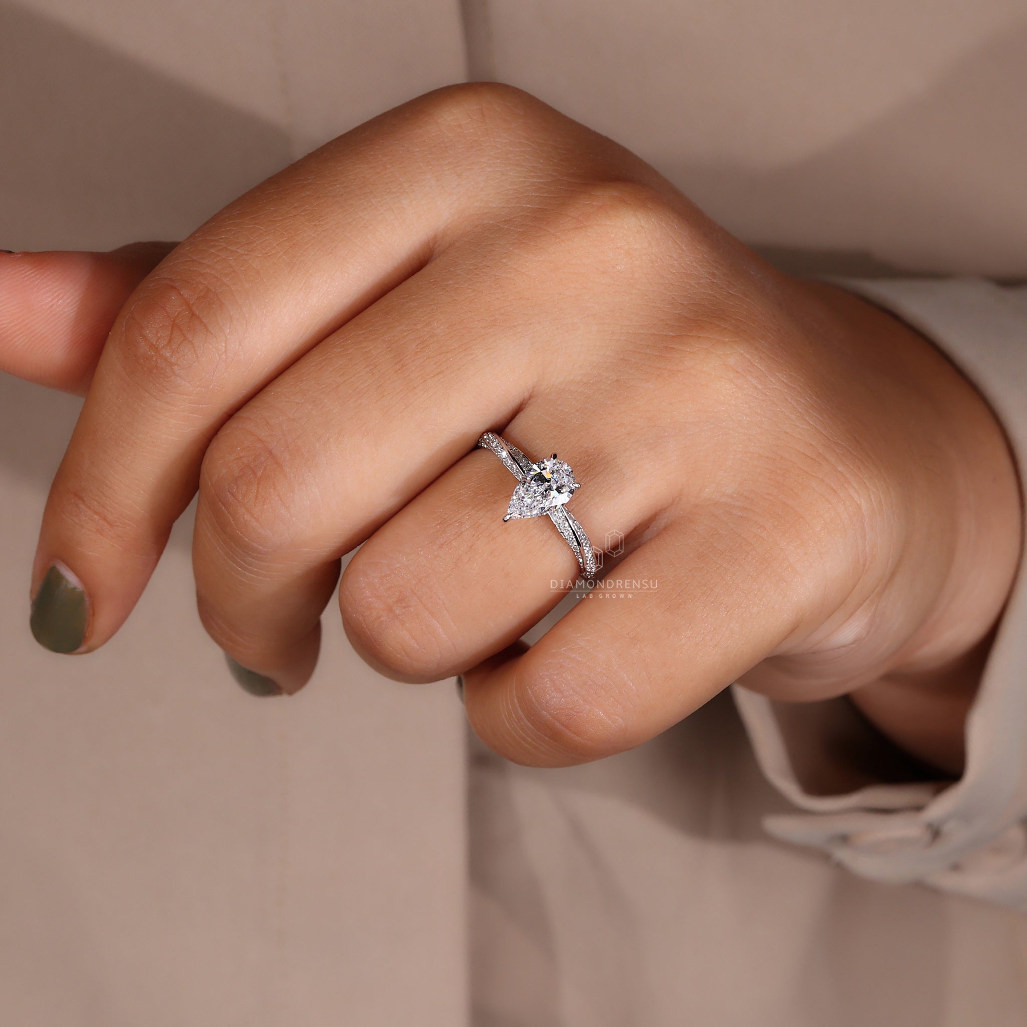 Hidden halo engagement ring with a sparkling lab grown pear diamond