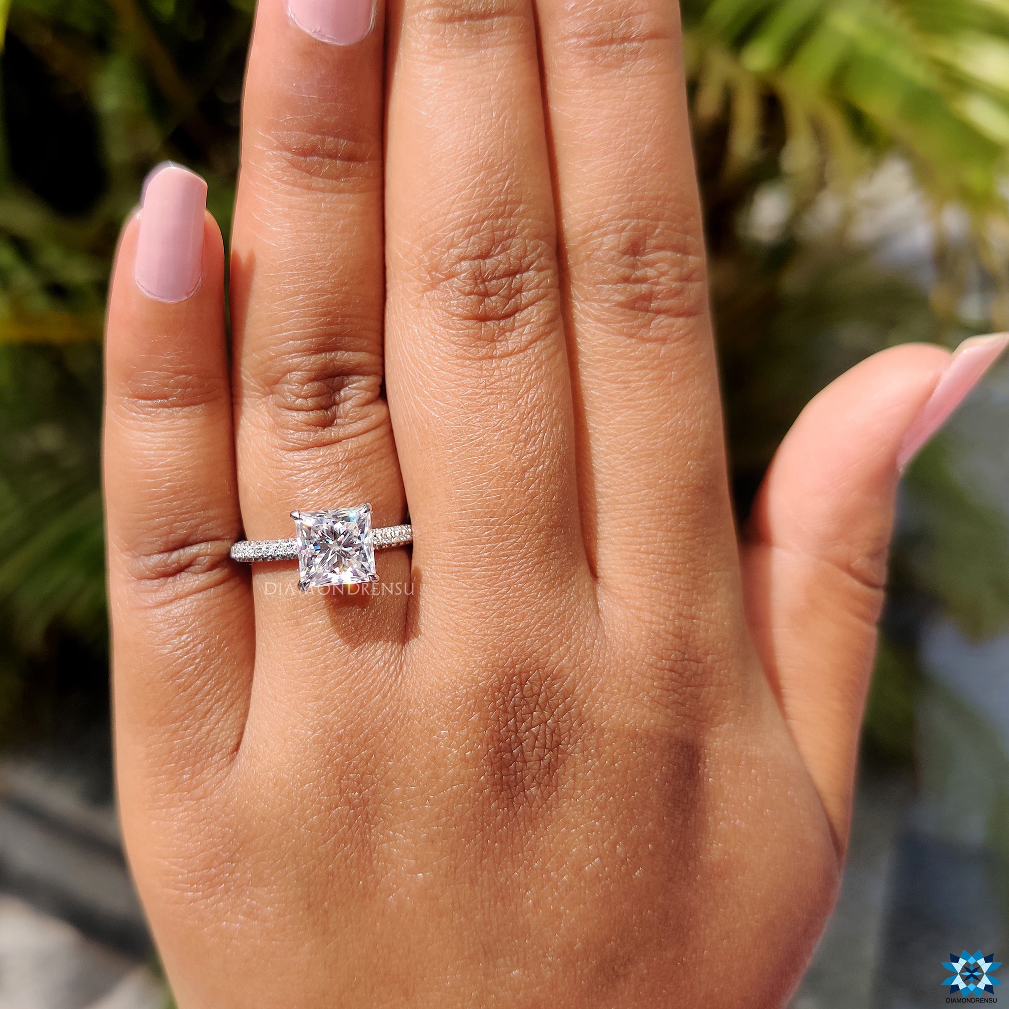 Moissanite engagement ring with white gold band and hidden halo setting.
