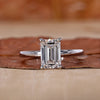 Emerald cut engagement ring with a hidden halo design.
