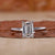 Emerald cut engagement ring with a hidden halo design.
