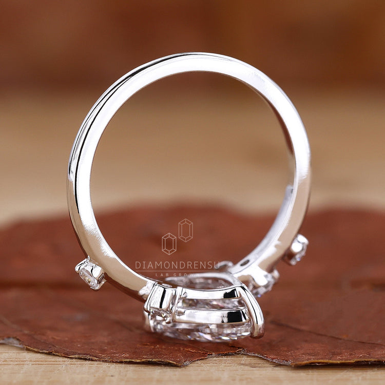 Pear shaped engagement ring with stunning round side stones.