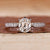 Old mine cushion cut diamond ring with pave set band in white gold.
