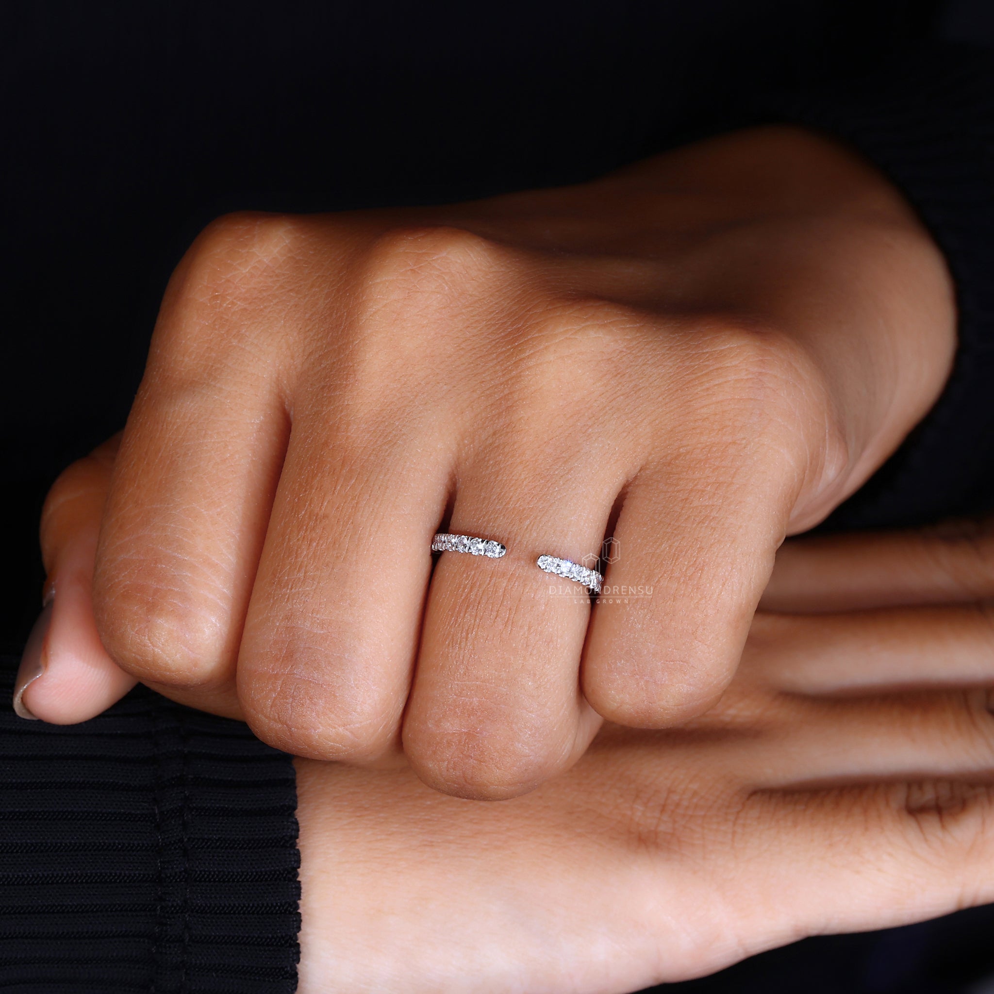 White gold open wedding band with round cut diamonds.
