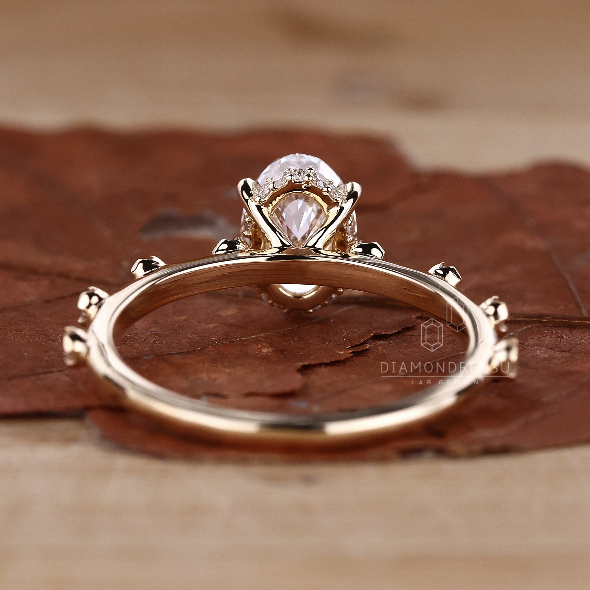 Diamondrensu handmade ring with hidden halo, oval cut diamond, and claw prongs, perfect for a timeless engagement.