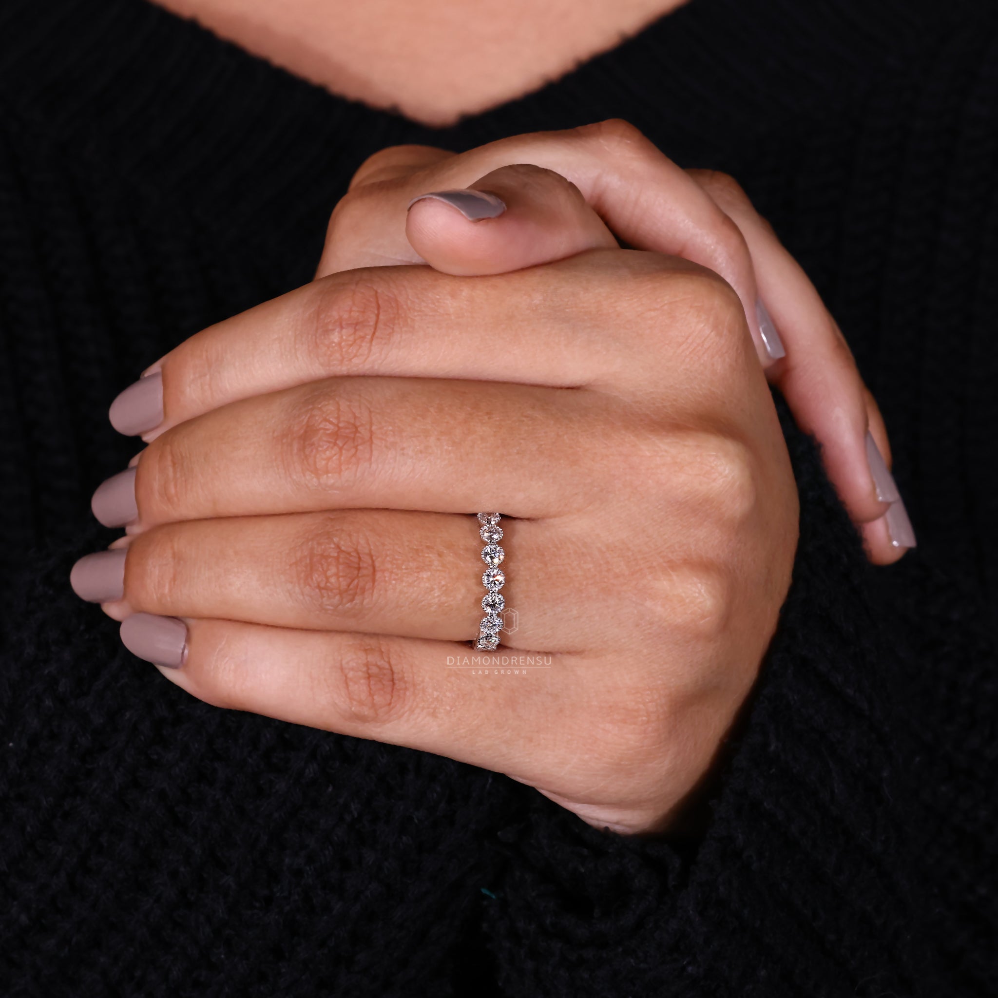 White gold wedding ring with round cut diamonds.
