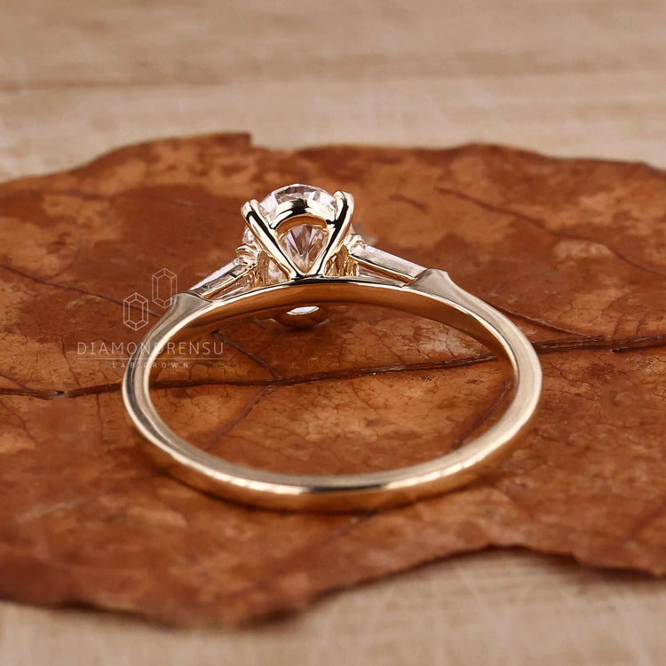 Oval shaped diamond ring in gold with prong claw setting, designed as a unique engagement ring for women.